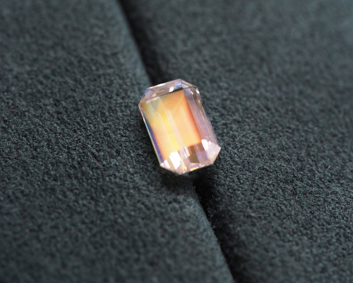 Rainbow moonstone in front of a green velvet background