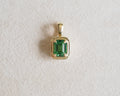 Robyn Natural tsavorite pendant place in front of a beige background.